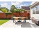 Cozy backyard patio area with outdoor dining set, umbrella, and fenced perimeter at 4707 N Park Ave, Indianapolis, IN 46205
