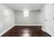 Open basement area with tiled floors, window, and access door at 4707 N Park Ave, Indianapolis, IN 46205