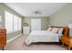 Bright bedroom with light green walls, a large window, and a comfortable queen bed at 4707 N Park Ave, Indianapolis, IN 46205