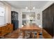 Bright dining area with a wooden table, chic light fixture, and black cabinet at 4707 N Park Ave, Indianapolis, IN 46205