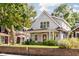 Charming two-story home with a welcoming front porch and a well-manicured lawn and garden at 4707 N Park Ave, Indianapolis, IN 46205