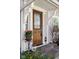 Close-up of the front door entrance featuring a stylish wood door with glass and stone steps at 4707 N Park Ave, Indianapolis, IN 46205