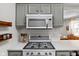 Close up of modern stainless steel microwave and gas range stove in kitchen at 4707 N Park Ave, Indianapolis, IN 46205