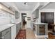 Charming kitchen with grey cabinets, tile floor, white counters, and stainless steel appliances at 4707 N Park Ave, Indianapolis, IN 46205