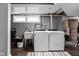 Basement laundry area with washer, dryer, utility sink, and storage space at 4707 N Park Ave, Indianapolis, IN 46205