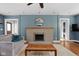 Comfortable living room featuring a cozy fireplace, hardwood floors, and blue walls at 4707 N Park Ave, Indianapolis, IN 46205