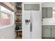 Pantry area with open shelving and modern white refrigerator at 4707 N Park Ave, Indianapolis, IN 46205