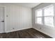 A bright bedroom with hardwood floors, wainscoting, and a large window at 4929 Young Ave, Indianapolis, IN 46201