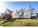 Inviting home with well-kept lawn and landscaping under a clear sky, situated next to neighboring homes at 4929 Young Ave, Indianapolis, IN 46201