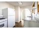 A modern kitchen with white cabinets, white appliances, hardwood flooring, and granite countertops at 4929 Young Ave, Indianapolis, IN 46201
