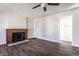 Open living room featuring a decorative brick fireplace, modern ceiling fan, and neutral walls at 4929 Young Ave, Indianapolis, IN 46201