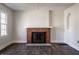 Cozy living room with brick fireplace, white trim, and new floors, offering comfort and style at 4929 Young Ave, Indianapolis, IN 46201