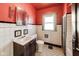 Retro bathroom with red walls, white tile, and a vanity sink at 518 Central S Ct, Indianapolis, IN 46205