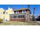 A side angle view of a two story brick home featuring a screened in porch at 518 Central S Ct, Indianapolis, IN 46205