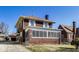 Two story brick home featuring a covered porch and a well-maintained lawn at 518 Central S Ct, Indianapolis, IN 46205