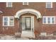 Close up of front door and entryway with a small porch and steps at 518 Central S Ct, Indianapolis, IN 46205