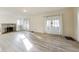 Sun-filled living room with fireplace, built-in shelving, and beautiful wood-look floors at 518 Central S Ct, Indianapolis, IN 46205