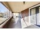 Spacious sunroom with brick walls, many windows, and doors on either side at 518 Central S Ct, Indianapolis, IN 46205