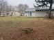 Spacious backyard with a mix of lawn and natural wooded areas, featuring a patio for outdoor enjoyment at 5212 Mason Cir, Indianapolis, IN 46254
