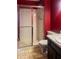 Cozy bathroom with a shower featuring sliding glass doors, a toilet, and a vanity with a sink at 5212 Mason Cir, Indianapolis, IN 46254