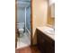 Bright bathroom featuring a vanity with sink, toilet, and a shower/tub with sliding glass door at 5212 Mason Cir, Indianapolis, IN 46254