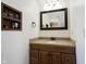 Bathroom vanity with a wood cabinet, tan countertop, and a decorative mirror at 6149 W Country Ln, Anderson, IN 46011