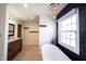 Bright bathroom with a soaking tub under a chandelier and a wood vanity at 6149 W Country Ln, Anderson, IN 46011