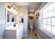 Bathroom with gray walls, modern vanity, and natural light from the window at 6149 W Country Ln, Anderson, IN 46011