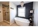 Modern bathroom featuring a soaking tub, glass shower, and stylish fixtures at 6149 W Country Ln, Anderson, IN 46011