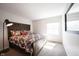 Cozy bedroom with a floral comforter and wood headboard with a window view at 6149 W Country Ln, Anderson, IN 46011