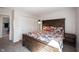 Comfortable bedroom with a wood bed frame, floral comforter and carpeted floors at 6149 W Country Ln, Anderson, IN 46011