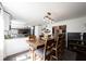 Dining area with a wooden table and view into the modern kitchen and living room at 6149 W Country Ln, Anderson, IN 46011