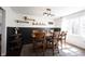 Inviting dining room with wood table, stylish rug, and black wainscoting detail at 6149 W Country Ln, Anderson, IN 46011
