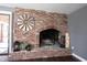 Close up of a brick fireplace with hearth, decorative accents, and access to a sliding glass door at 6149 W Country Ln, Anderson, IN 46011