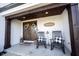 Charming front porch with rocking chairs, double doors, and tasteful decor, offering a warm welcome at 6149 W Country Ln, Anderson, IN 46011
