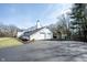 Detached two-car garage with an asphalt driveway and mature trees at 6149 W Country Ln, Anderson, IN 46011
