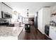 Well-lit kitchen features stainless appliances, granite countertops, a center island, and hardwood floors at 6149 W Country Ln, Anderson, IN 46011
