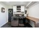 Well-lit laundry room with built-in shelving and counter, stainless steel washer and dryer, and stylish decor at 6149 W Country Ln, Anderson, IN 46011