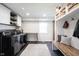 Well-lit laundry room with built-in shelving and bench, stainless steel washer and dryer, and neutral decor at 6149 W Country Ln, Anderson, IN 46011