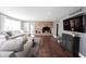 Spacious living room with a brick fireplace, hardwood floors, and an abundance of natural light at 6149 W Country Ln, Anderson, IN 46011