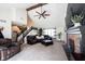 Spacious living room with vaulted ceiling, ceiling fan, fireplace, carpet and staircase at 6149 W Country Ln, Anderson, IN 46011