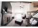 Spacious living room with a ceiling fan, fireplace, and leather seating at 6149 W Country Ln, Anderson, IN 46011
