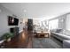 Bright living room with hardwood floors, brick fireplace, and gray walls creates a cozy and inviting atmosphere at 6149 W Country Ln, Anderson, IN 46011