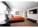 Large main bedroom with plenty of natural light, a TV, and neutral carpet at 6149 W Country Ln, Anderson, IN 46011