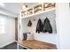 Mudroom with cubbies, coat hooks, bench seating, and wood accents for organized and stylish storage at 6149 W Country Ln, Anderson, IN 46011
