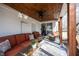 Inviting porch with comfortable seating, ceiling fan, and wood ceiling, ideal for relaxing outdoors at 6149 W Country Ln, Anderson, IN 46011
