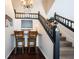 Open landing with built-in desk, stairs and black and wood railing at 6149 W Country Ln, Anderson, IN 46011