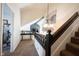 Upstairs landing area with staircase and chandelier at 6149 W Country Ln, Anderson, IN 46011
