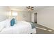 Sun-filled bedroom with a ceiling fan, two windows, and an ensuite bathroom at 6216 N Woods Edge Ct, McCordsville, IN 46055