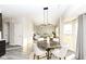 Bright dining space with modern lighting fixture and comfortable seating, seamlessly connected to the living area at 6216 N Woods Edge Ct, McCordsville, IN 46055
